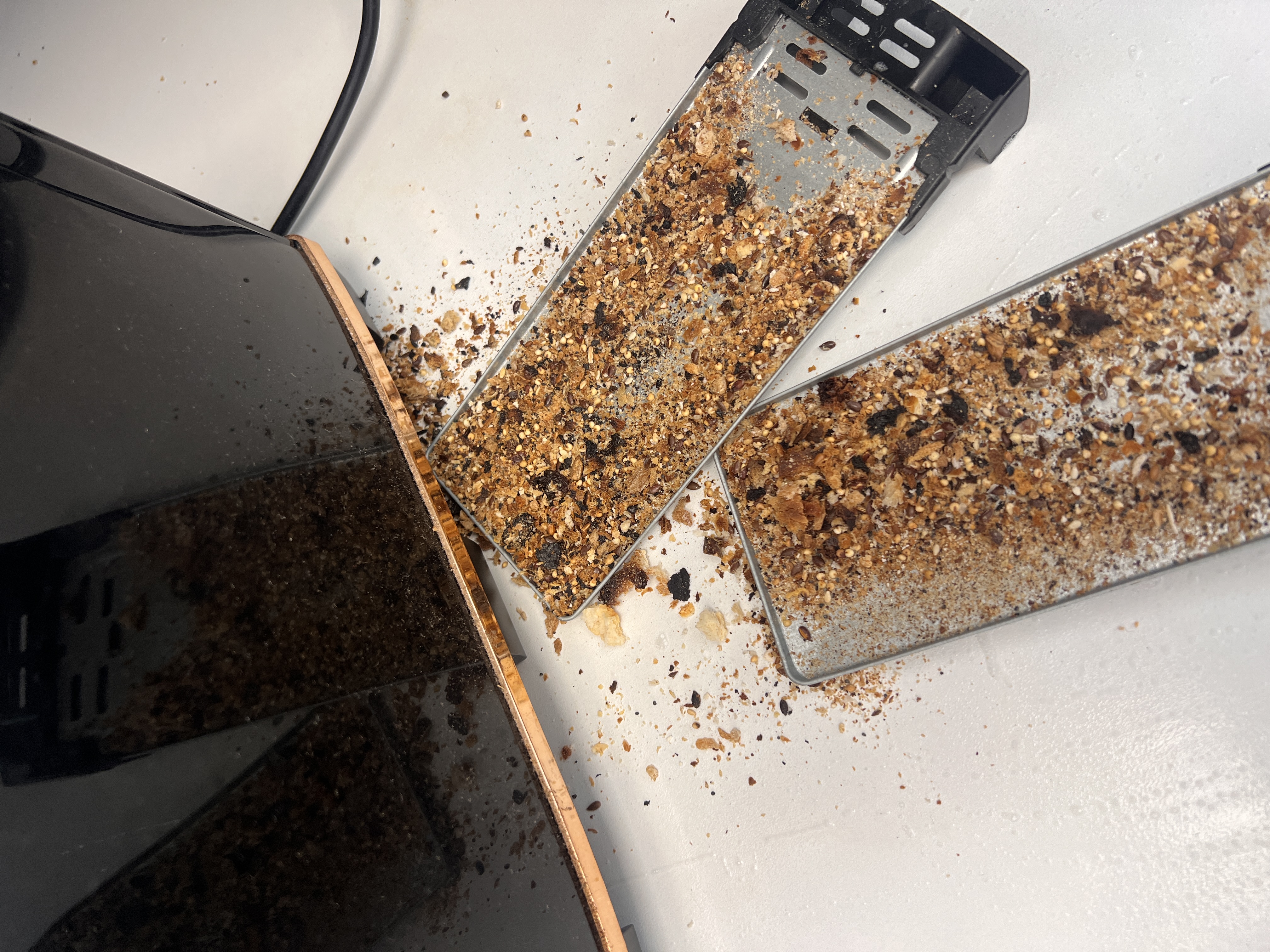 Toaster crumb trays before cleaning